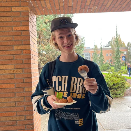 A student getting a donut from a community life pop-up event