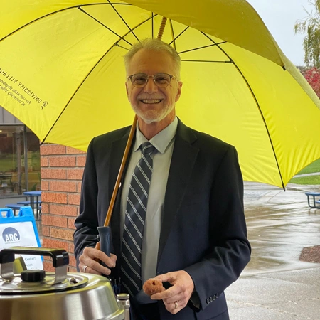 Robin Baker getting a donut from a commuter life pop-up event