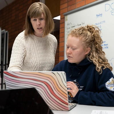 Teacher helping a student 