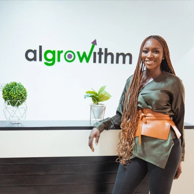 Bili Sule in front of an alGROWithm sign