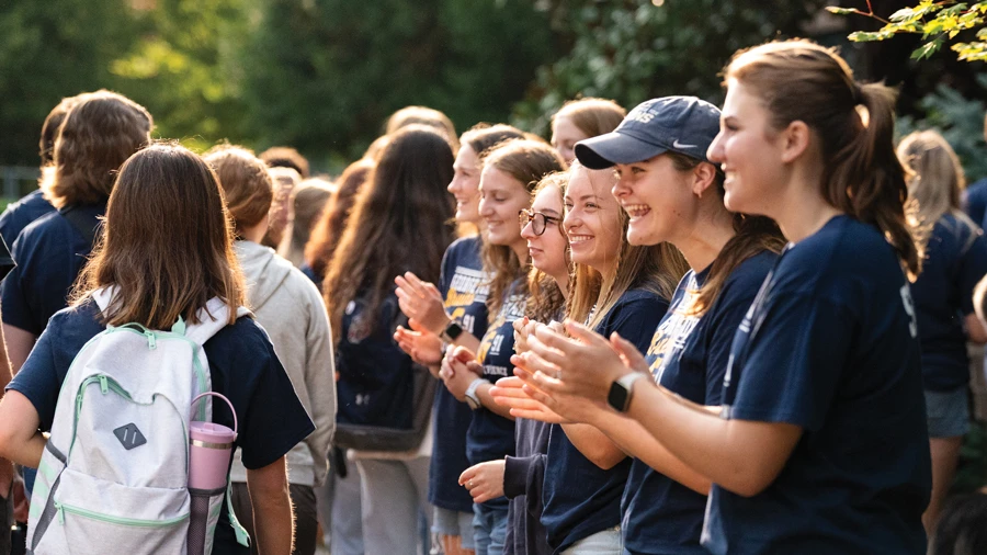 students at a retreat cheering others on