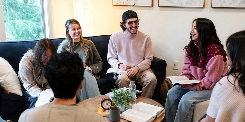 Students with their Bible sitting and having a discussion