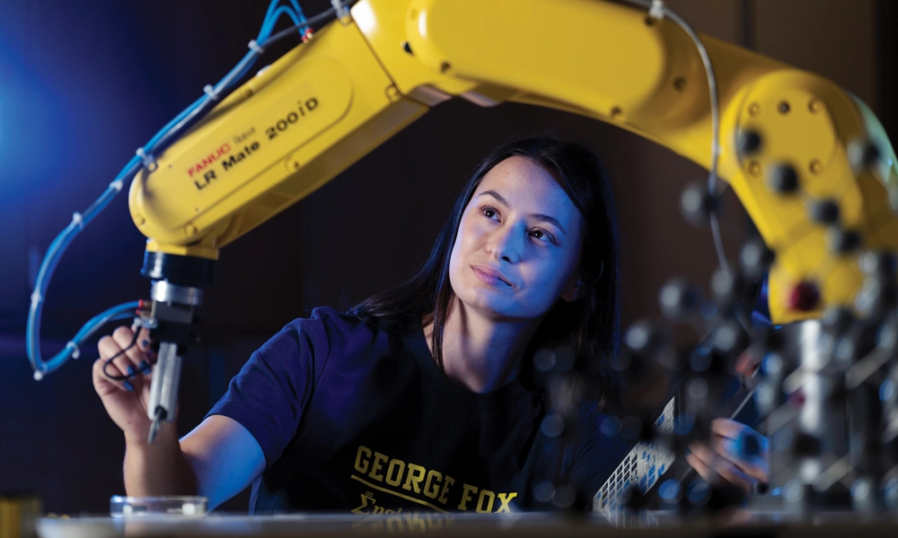 engineering student working with a machine
