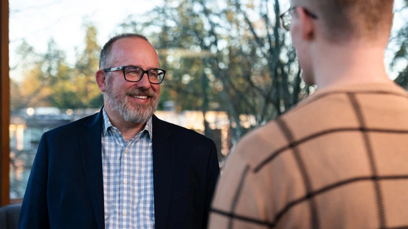 Troy Fisher talking with a student
