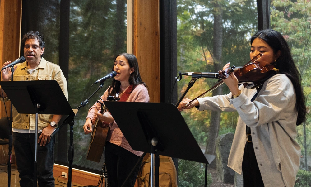 staff worshipping at GFU's monthly all-employee meeting