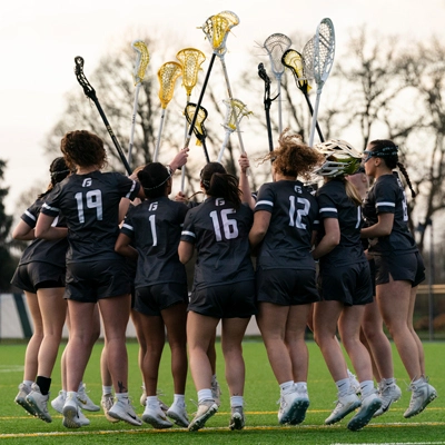 the lacrosse team celebrating on the field