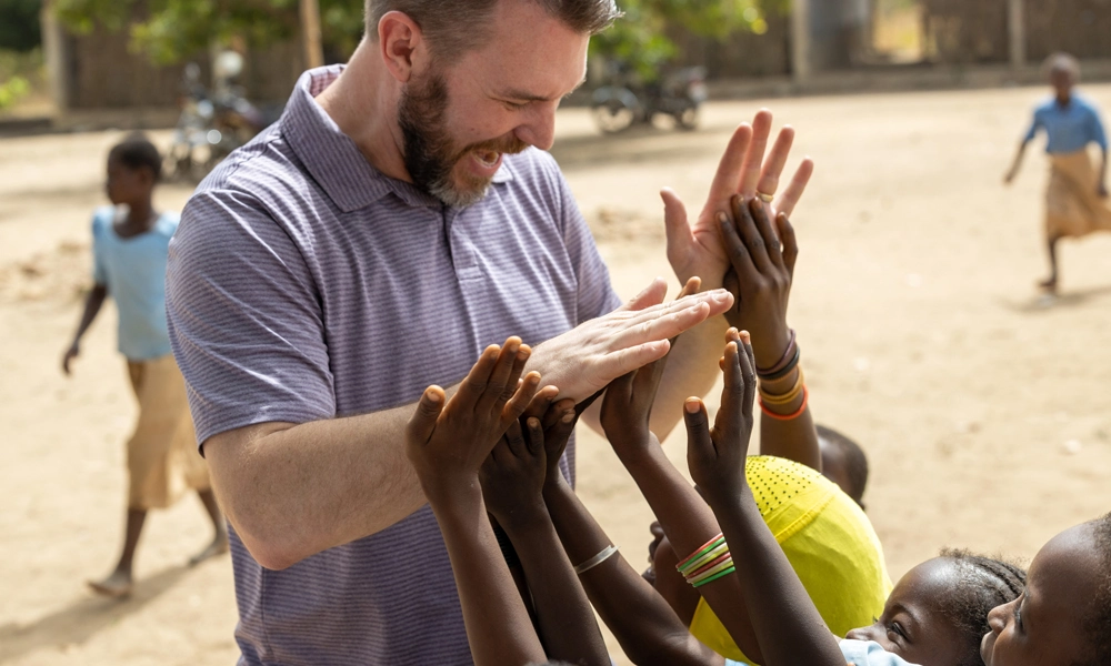 Trevor Owen giving kids a high-five