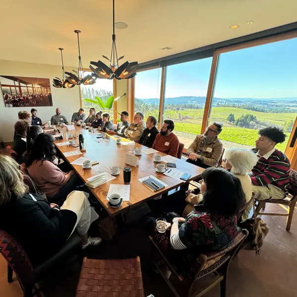 Humanitarian leaders sit around a table and share a mea;
