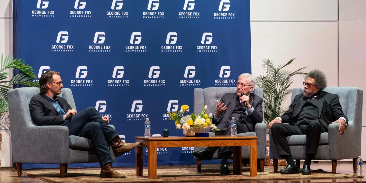 Joseph Clair facilitates a discussion between Robert George and Cornel West at George Fox