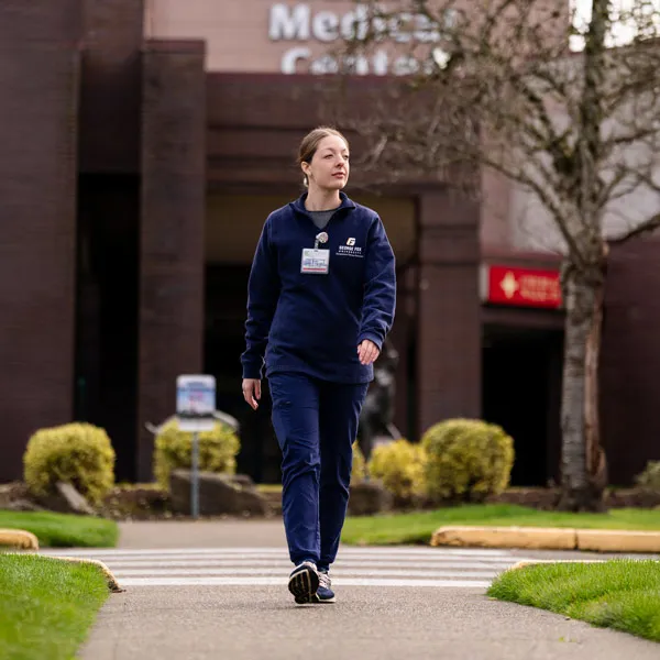 Makayla Clark leaves the medical building wearing scrubs