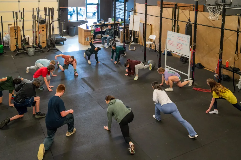 Adri Salazar leads a group youth fitness class in a gym