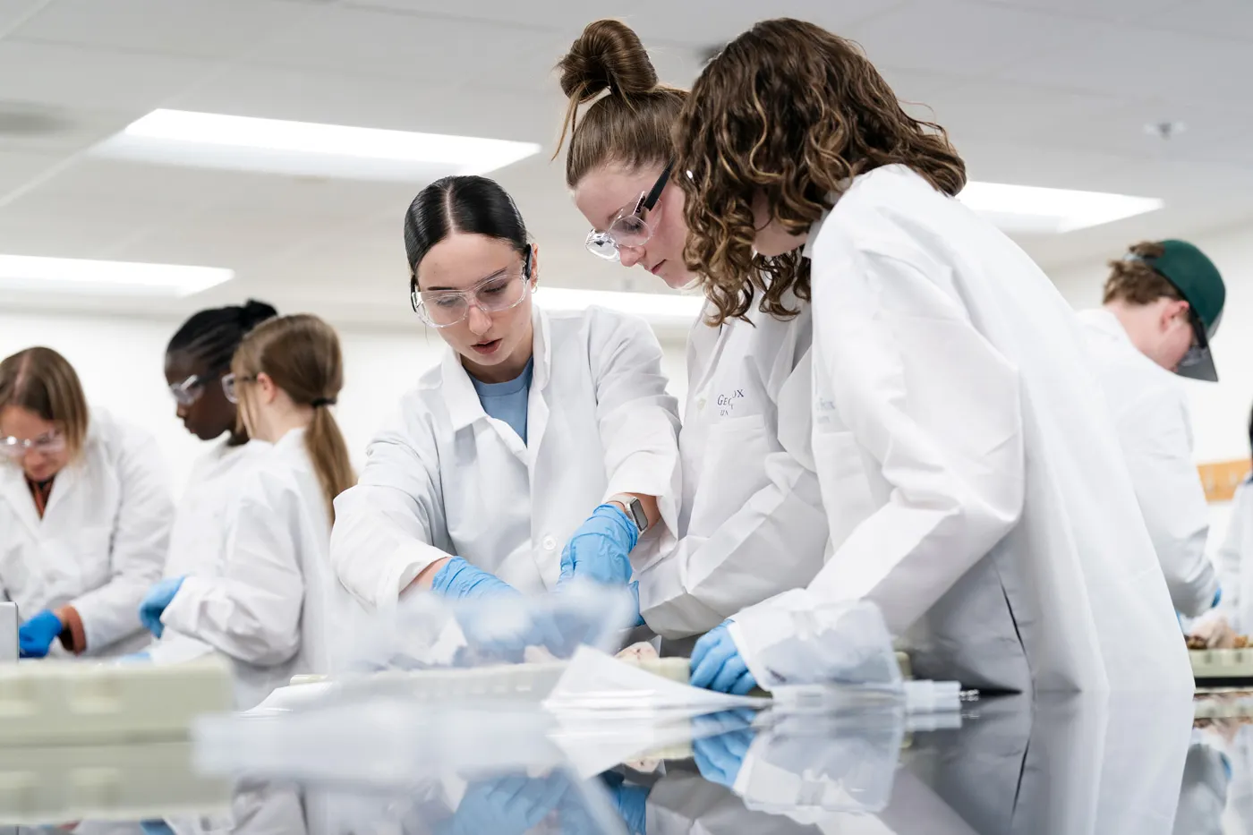 George Fox medical student works with a patient in an office