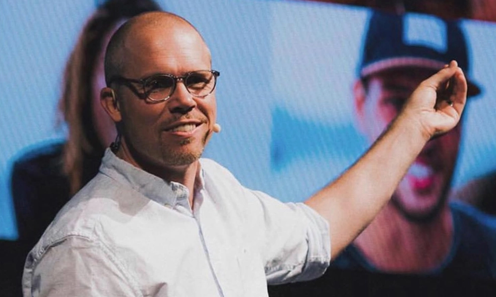 Ben Sand presenting while standing in front of a screen
