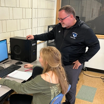 Martz helping a student while they work on a computer