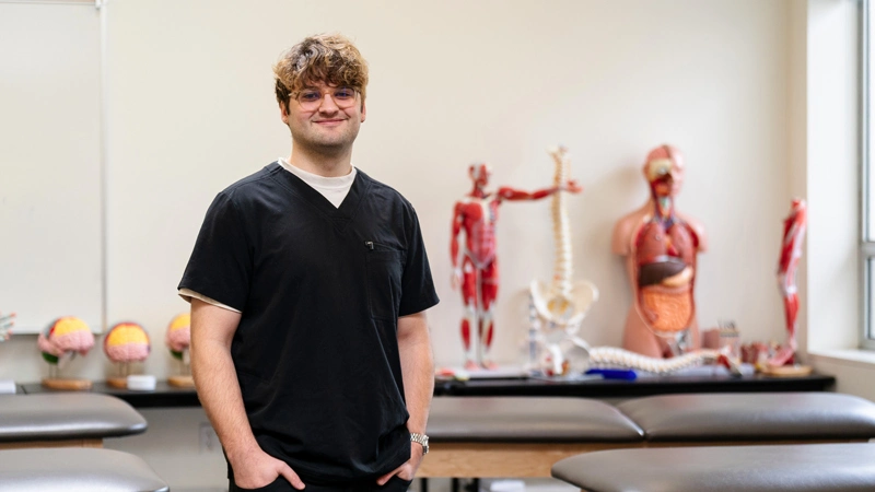 portrait of Connor in scrubs in the George Fox OT facility