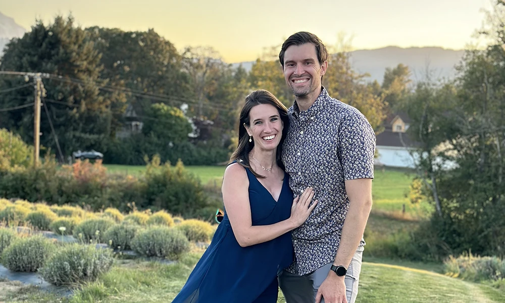 Matt Roth and his wife smiling, posing in a garden.