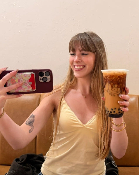 Grace smiling and holding a boba drink