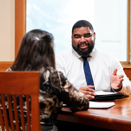 two business professionals discussing something at a table