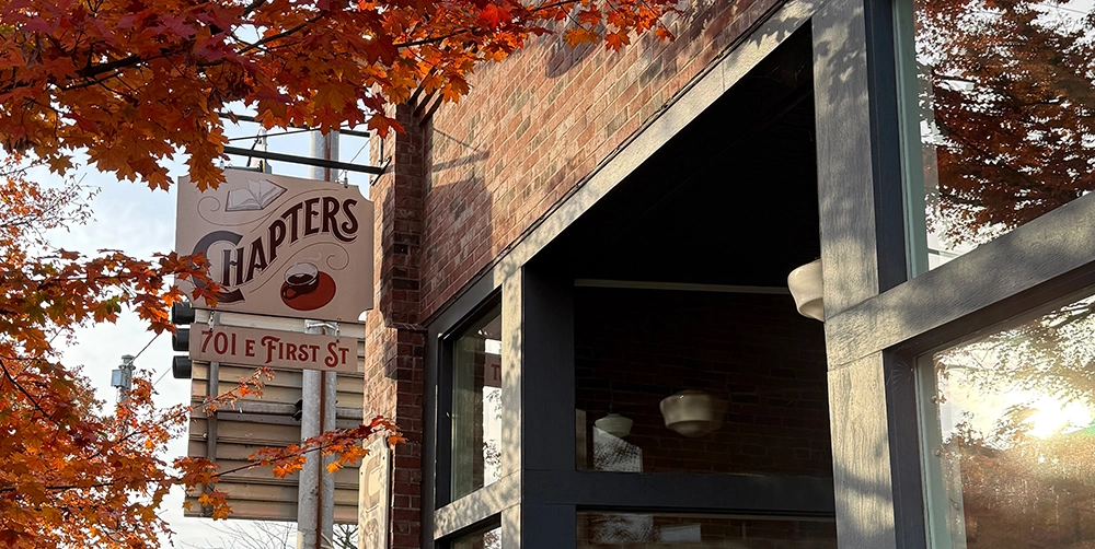 Entrance to Chapters coffee shop with a sign that reads 'Chapters' and the address