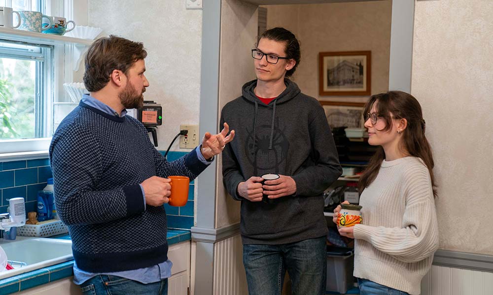 Travis and students in a kitchen