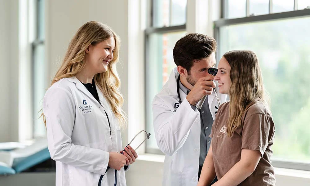 Two medical students examining a patient