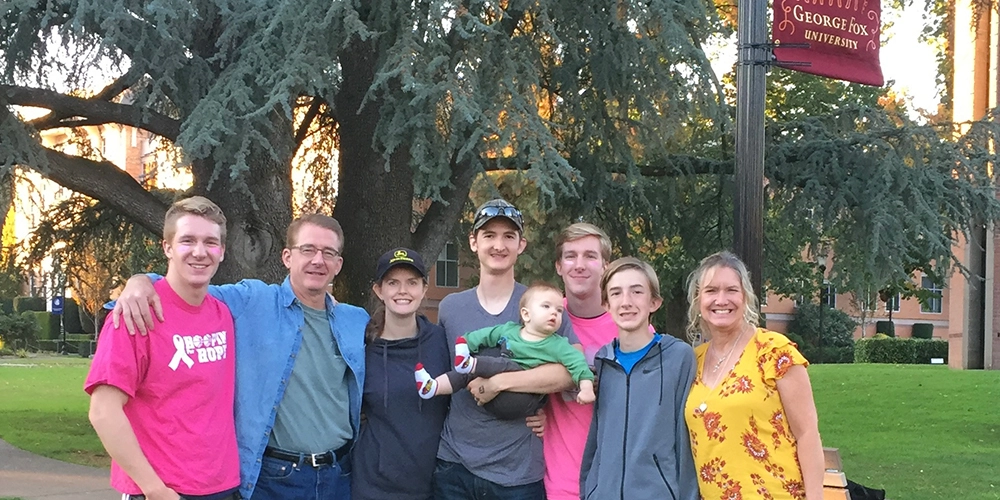 A family of eight standing and smiling for the camera