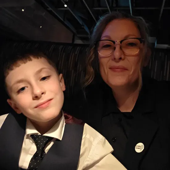 Vicki smiles with her young son for a selfie