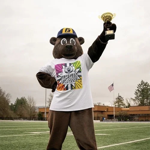 Mascot Pennington holds up a trophy