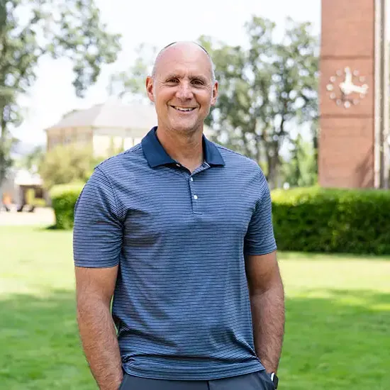 Darren McGraw stands in front of the clock tower on campus