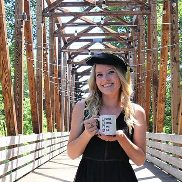 Sarah Cooley smiles on the bridge on campus