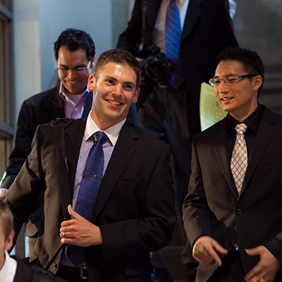 Student in graduation outfit looking at the camera