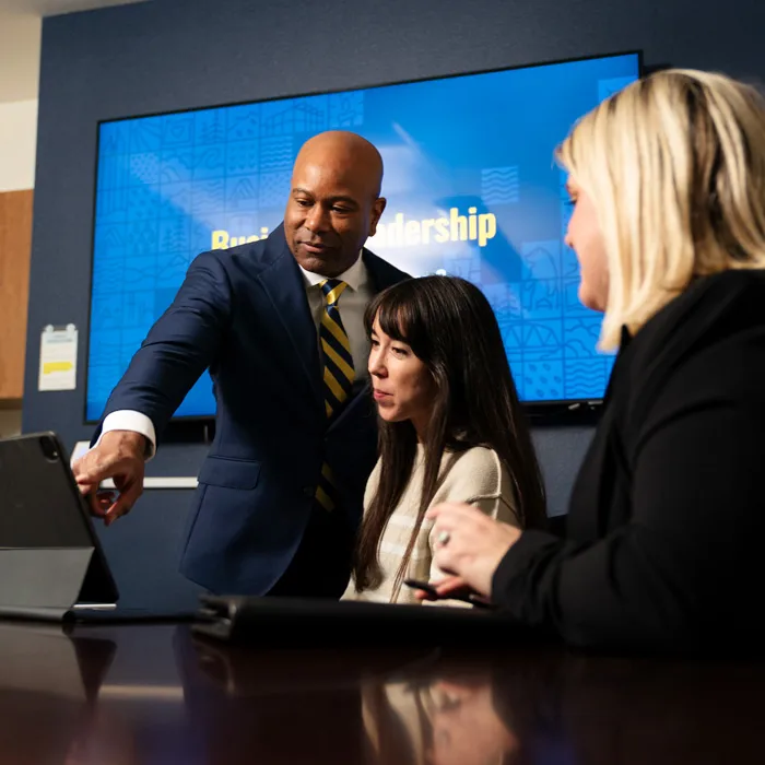 business professionals talk about AI on a laptop