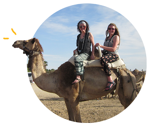 Two students riding on a camel