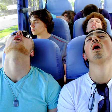 Tired students sleeping on the bus