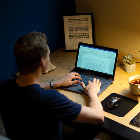 student works on laptop.