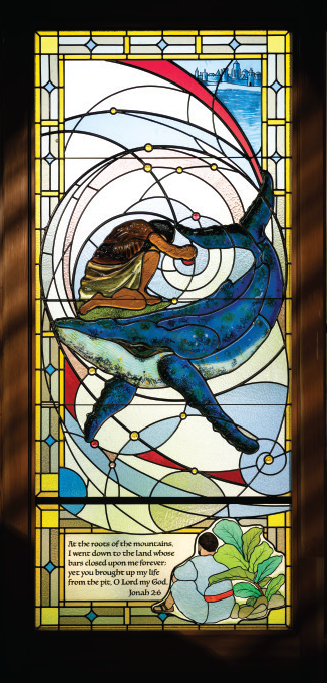 Stained glass window depicting Jonah swallowed by the great fish, illustrating Jonah 2:6