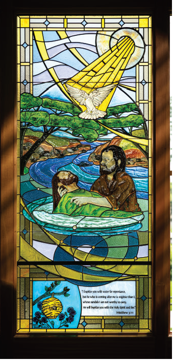 Stained glass window depicting John the Baptist and the baptism of Jesus, illustrating Matthew 3:11