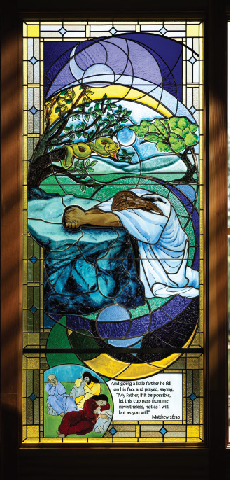 Stained glass window depicting Jesus praying in the Garden of Gethsemane, illustrating Matthew 26:39