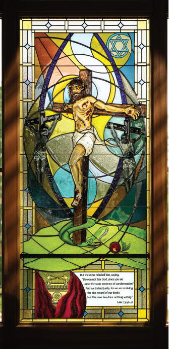 Stained glass window depicting Jesus on the cross alongside the penitent thief, illustrating Luke 23:40-41