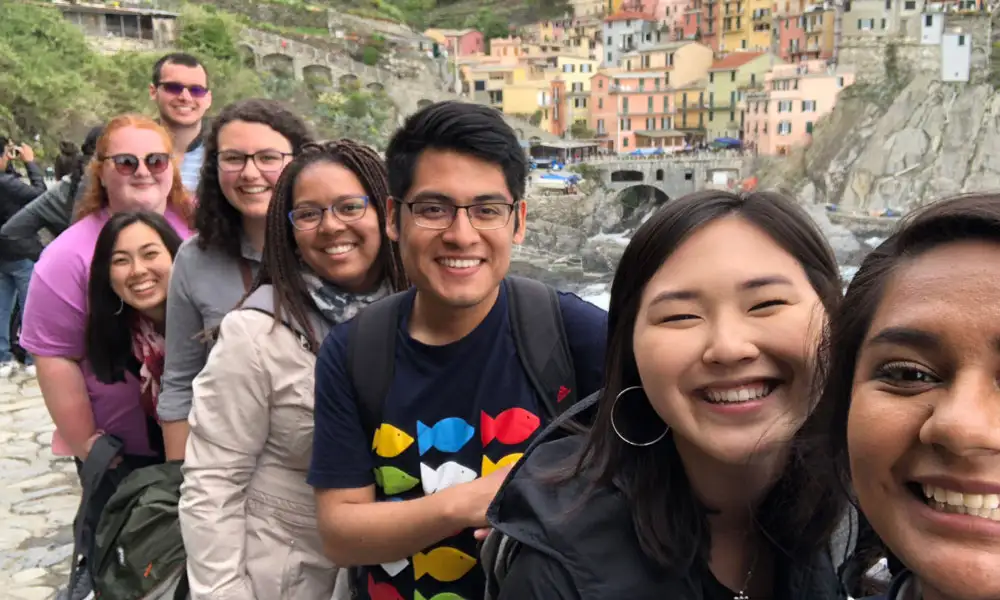 Students taking a selfie at a viewpoint above colorful buildings
