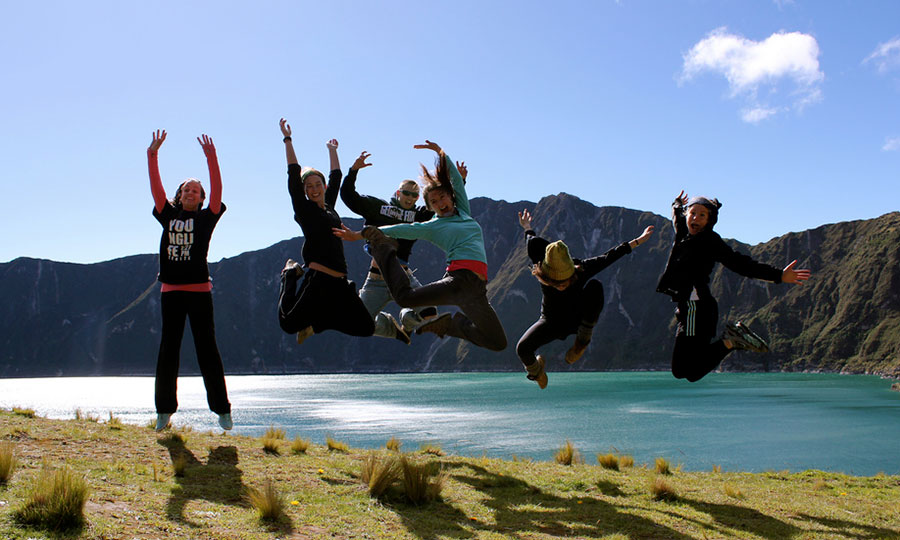 Excited students jump for a photo in Ecuador