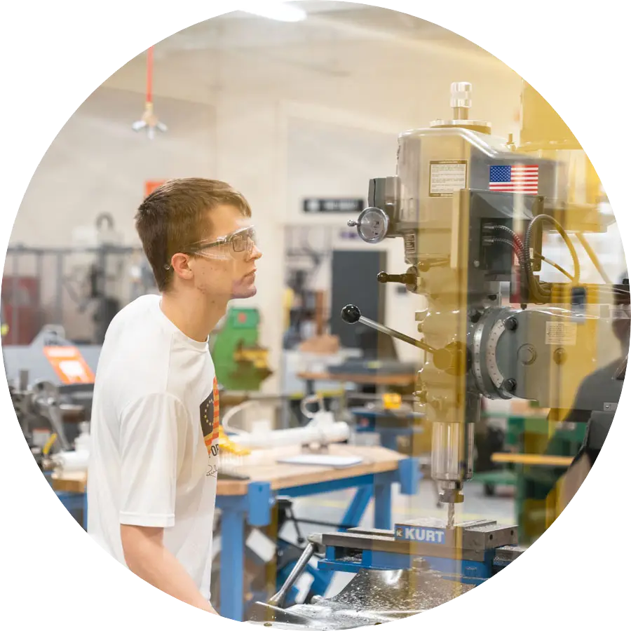 Student works on machinery in the Maker Hub