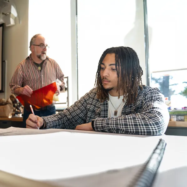 Student works on a stained glass project in the new art building
