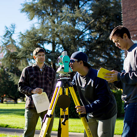 civil engineering students surveying on the campus quad