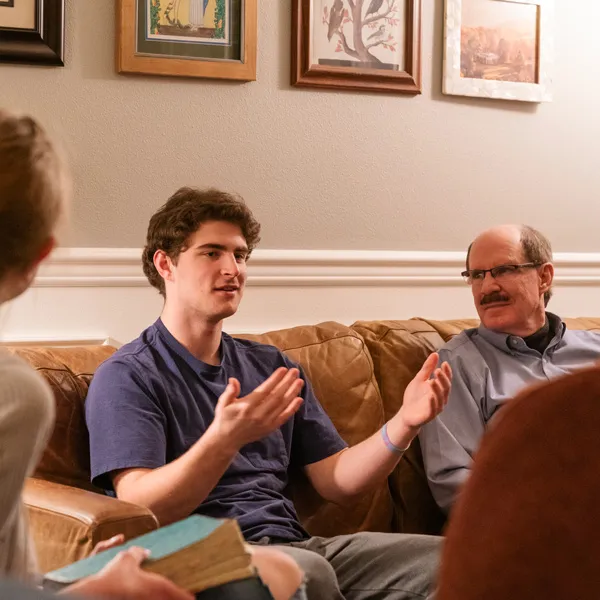 Student have deep discussions at a professor's house
