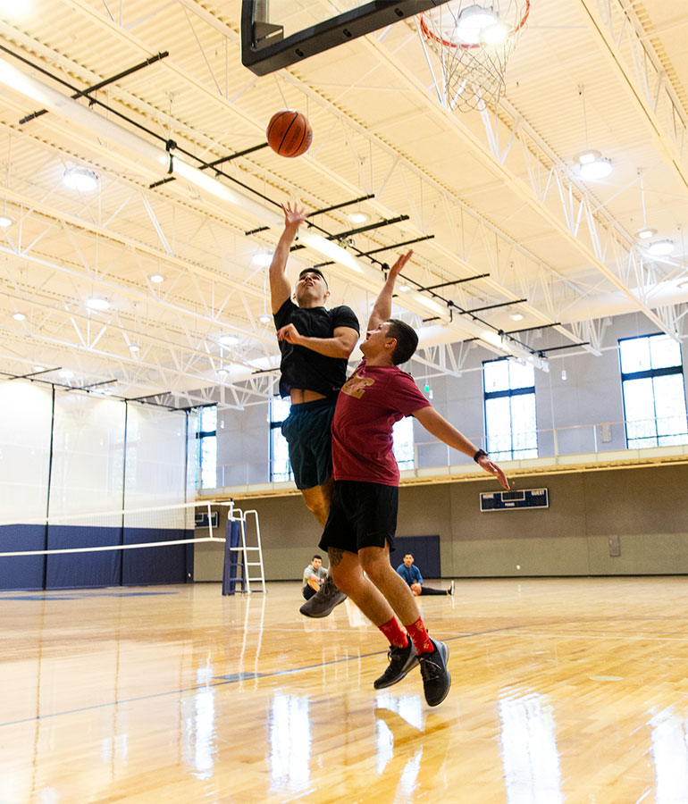 Two students playing basketball in Hadlock Student Center