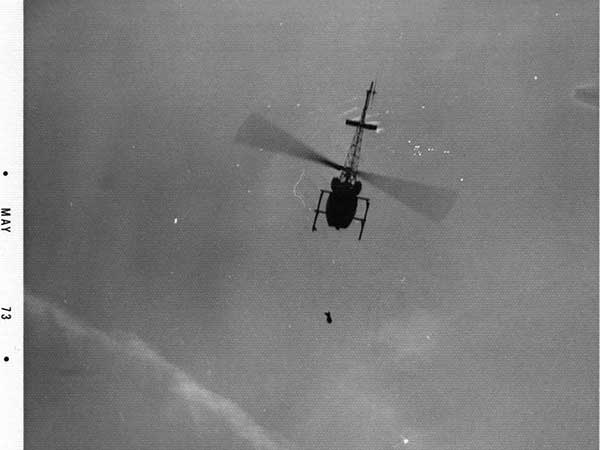 1973 helicopter hovers over the campus