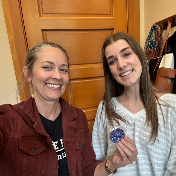  Erin Mitchell and Tamara smile and take a selfie in Tamara's office