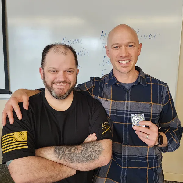 Jayson and Ryan pose for a photo in the classroom