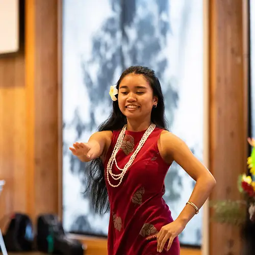 Hawaii club member dances with a flower in her hair